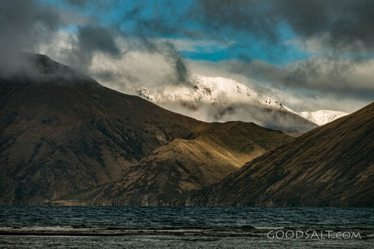 Storm Clouds Over Snowcapped Mountains