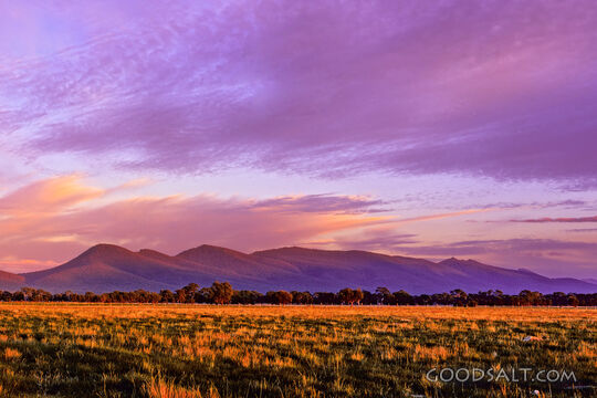 Mountains in summer with grazing land and with dramatic sky.