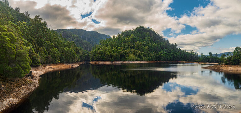 Perfect reflection of forest covered banks in lake.