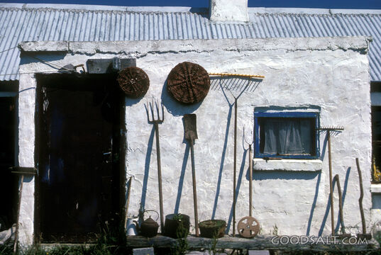 Tools leaning against building.