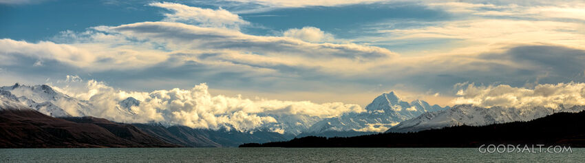 Prominent mountain range behind lake waters.