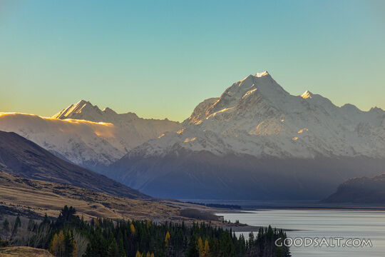 Prominent mountain range behind lake waters.