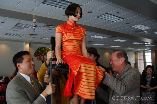 IDAHO. Boise. Asian Jewish girl lifted by her father and gra
