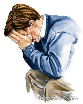 A man holding his hands to his face.
