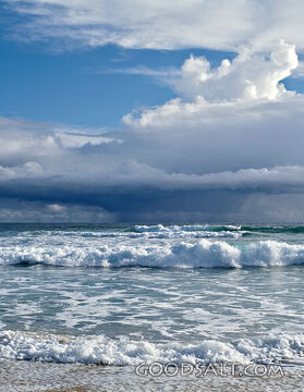 seascape with frothy waves and puffy clouds