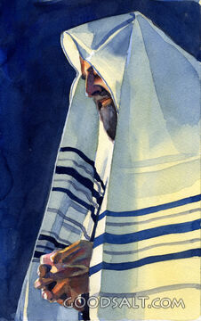 A praying man with a cloth on his head.