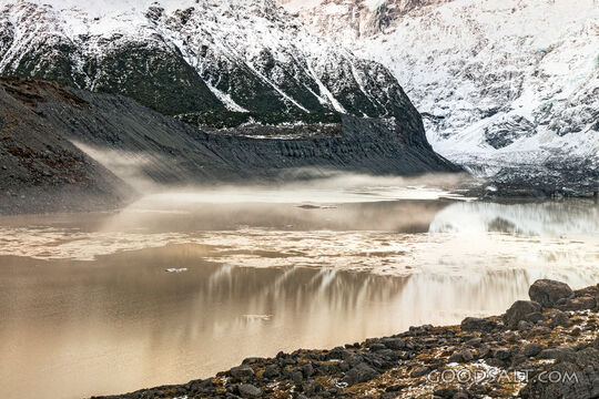 Spectacular alpine scenery of rocks, boulders, snow and water.