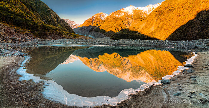 Spectacular landscape of an icy flood hole beside glacial river.