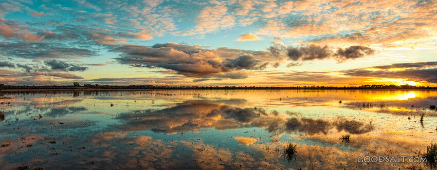 Spectacular sunset and reflection on surface of shallow lake.