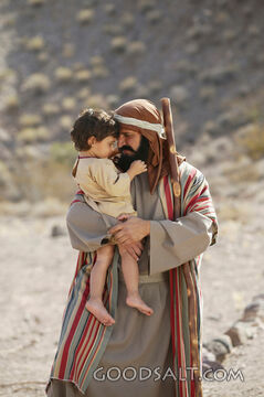 man holding child in his arms - close up
