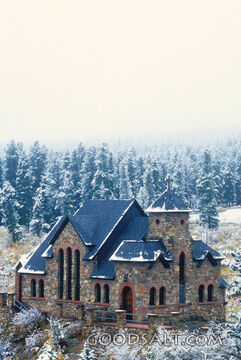 Stone Church Surounded by Trees in the Snow