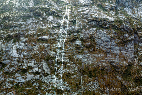 Stunning scenery which contains a waterfall in alpine remote landscape.