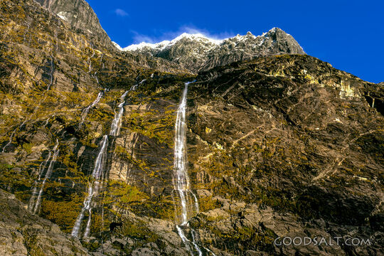 Stunning scenery which contains a waterfall in alpine remote landscape.