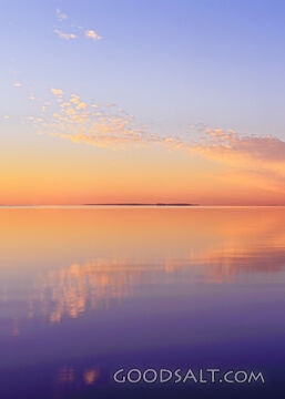 Sunrise on lake with mirror reflections.