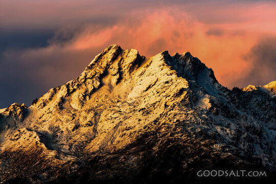 Sunset light on faces of lpine range.