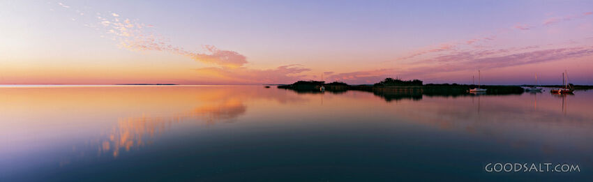 sunset over water with island