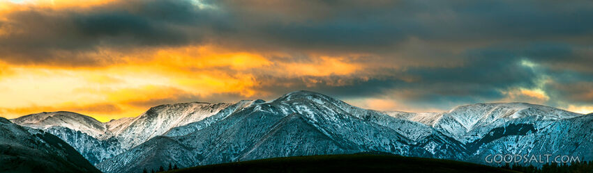 The light of the early sunrise collides with a mountainside.