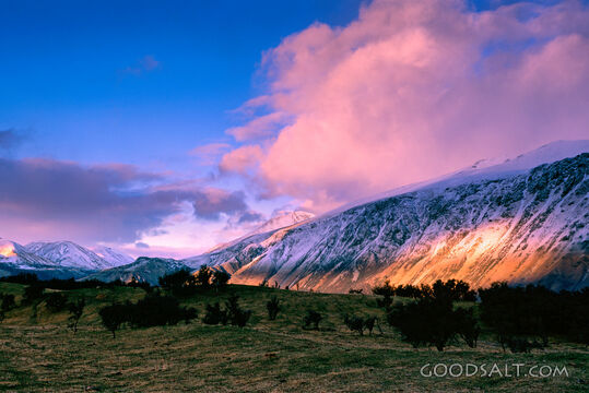 The light of the early sunrise collides with a mountainside.