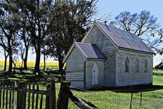 whitewashed church and wooden fence