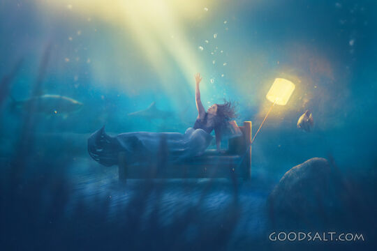 Woman at bottom of sea reaching for help