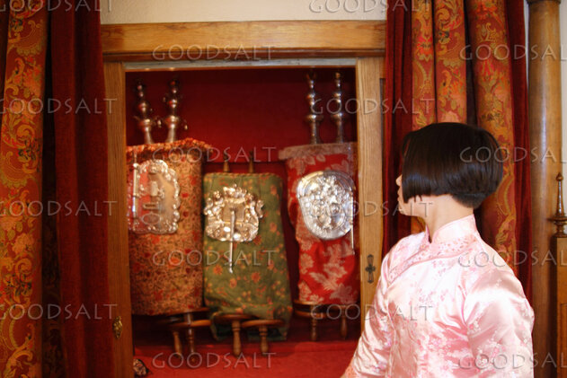 IDAHO. Boise. Asian Jewish girl looking at Torah in ark. MR