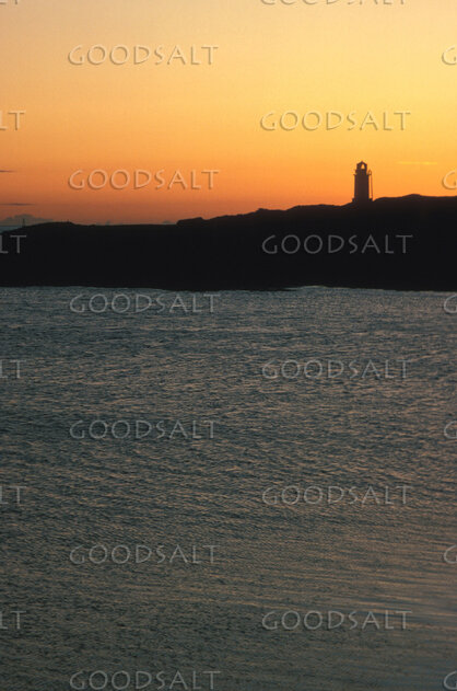 Lighthouse at Sunset Over the Sea