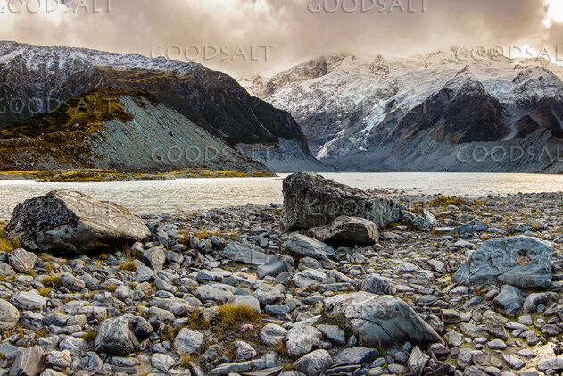 Spectacular alpine scenery of rocks, boulders, snow and water.