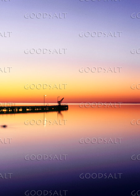 Sunrise on lake with mirror reflections.