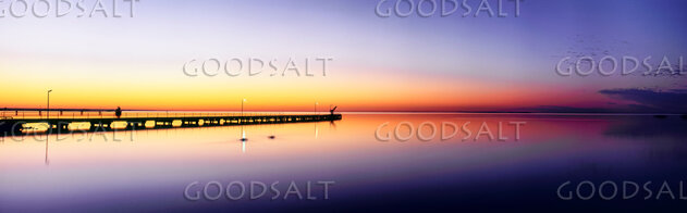 Sunrise on lake with mirror reflections.