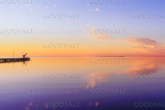 Sunrise on lake with mirror reflections.