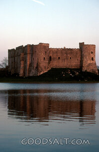 ancient castle reflected in a rippling lake