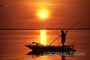 Boy Poling His Outrigger Canoe in the Trobriand Islands