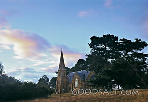 church amongst trees with pink clouds