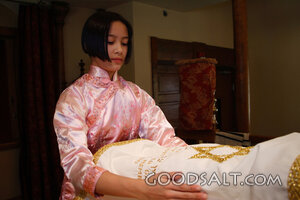 IDAHO. Boise. Asian Jewish girl placing cover over Torah at