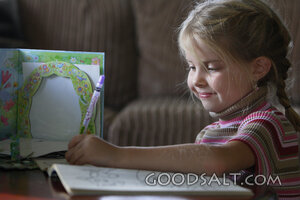 IDAHO. Boise. Little girl coloring, left handed. MR