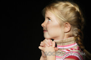 IDAHO. Boise.  Little girl looking up and praying. MR
