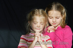 IDAHO. Boise.  Little girls praying with eyes closed. MR