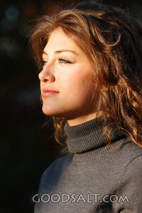 IDAHO. Boise. Young woman looking up into light (close-up).