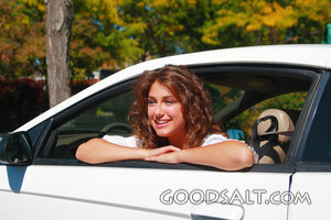 IDAHO. Boise. Young woman seated in sports car, smiling. MR