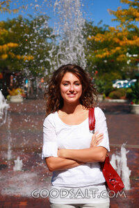 IDAHO. Boise. Young woman smiling in front of fountain.  MR