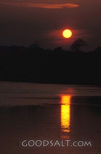 Sunset Reflection Over Still Waters