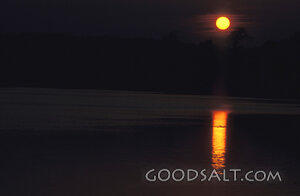 Sunset Reflection Over Still Waters