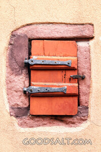 Rustic Shutter in Stone Wall
