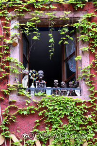 Vine-Covered Window with Carved Figures