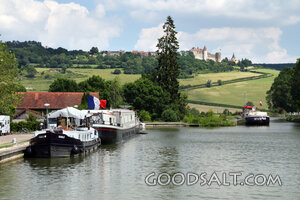 Canal Harbor Below a French Hilltop Village