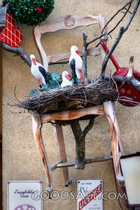 Storks Nesting in a Rustic Chair