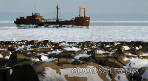 Frozen Shipwreck on a Rocky Shore