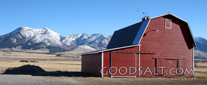 Red Barn Beneath the Mountain Peaks