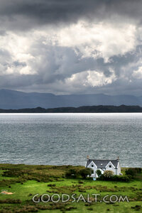 Coastal Cottage Under Storm Clouds