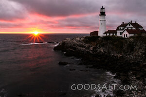 Lighthouse at Sunset Over the Rocky Coast